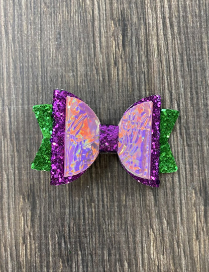 Iridescent mermaid bow with purple and green glitter- approximately 3 inches across.