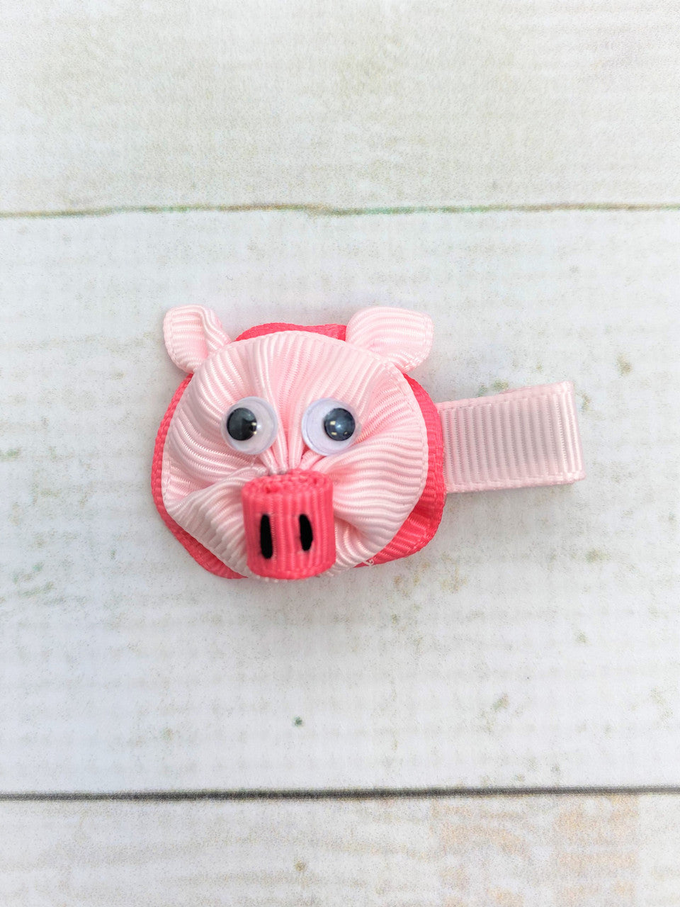 Pig Clippie made of grosgrain ribbon with googly eyes.