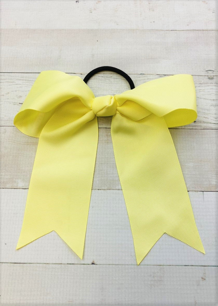 Light yellow cheer bow with ponytail elastic