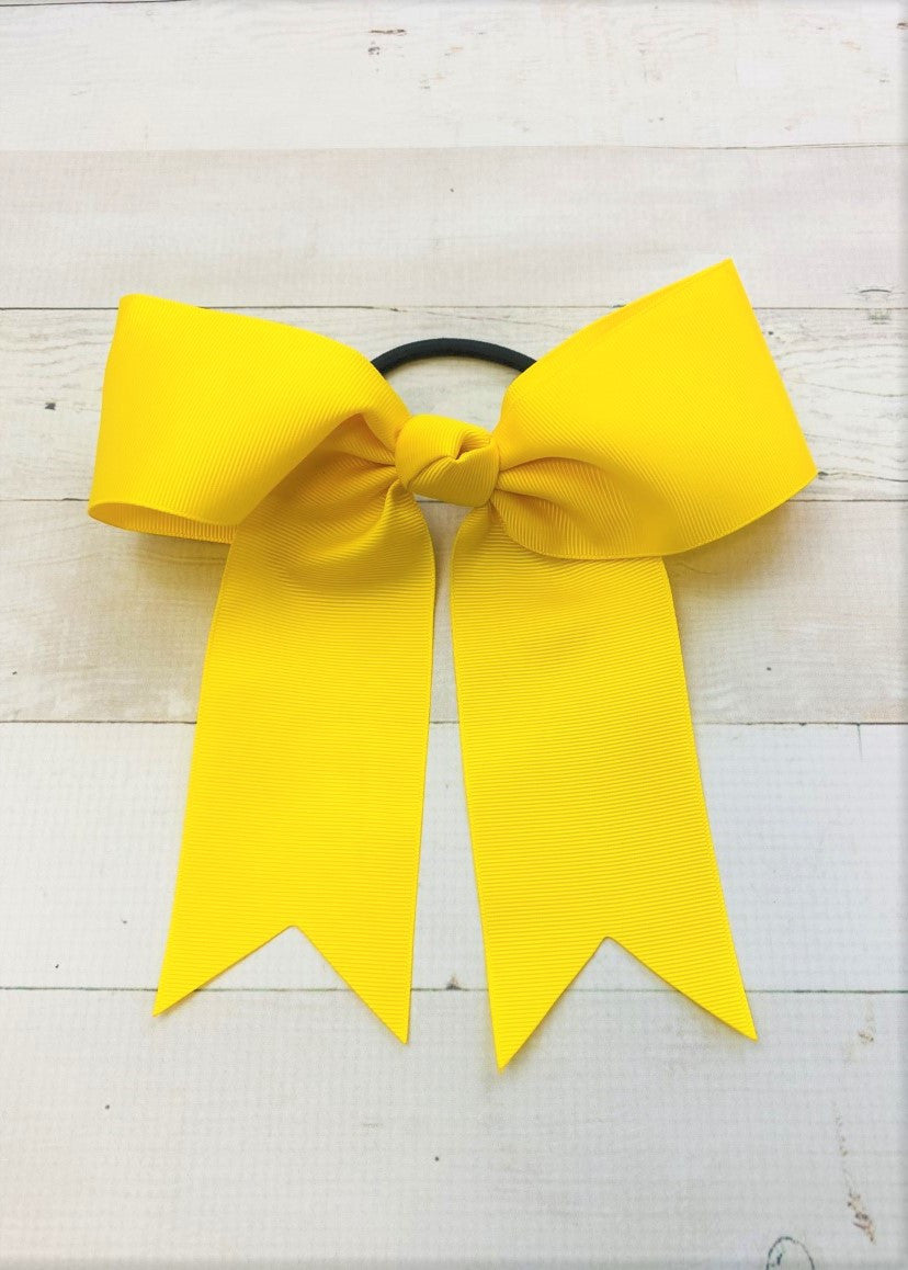 Bright yellow cheer bow with ponytail elastic