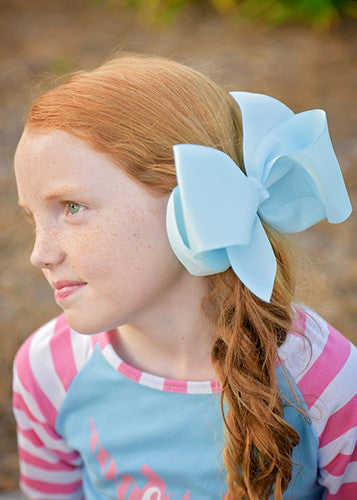 Light Blue Texas size hair bow with French clip on a model