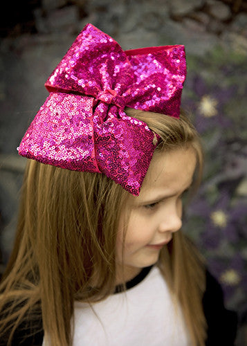Texas size sequin bow in hot pink on model