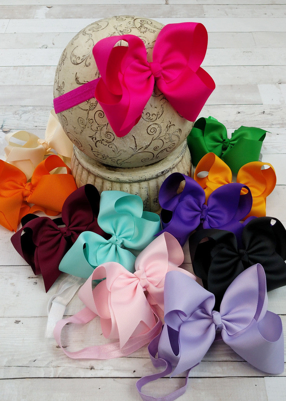 Classic oversized hair bow on a satin headband. Satin headbands are 18cm laying flat and stretch to fit a wide age range. Most headbands match the bow color, some are black or white; please see photos.