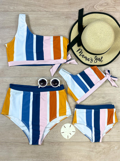 Mommy and me one shoulder navy, orange, mustard, and light pink striped with a bow tied on the side, top paired with matching bottoms bikini set.