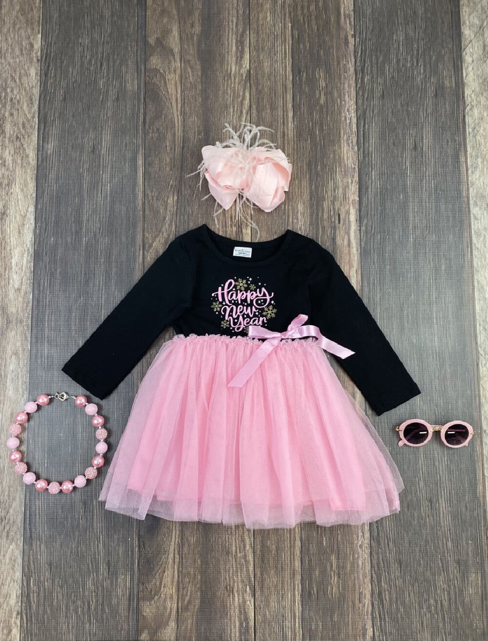 Happy New Year black long sleeve & pink tulle dress with satin bow accent. 