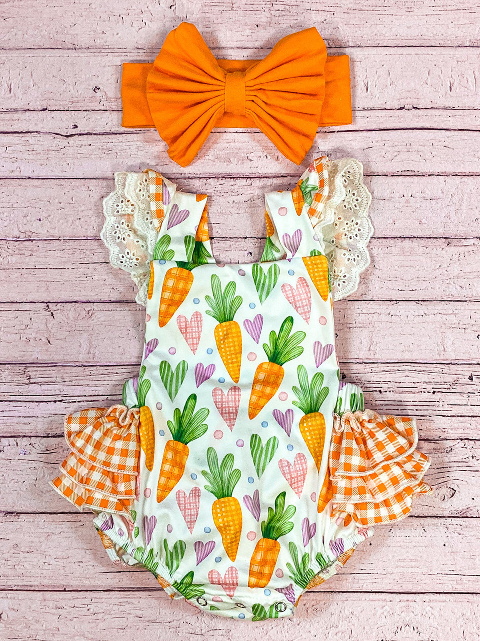 White lace ruffle sleeves with carrots and pink heart pattern and layered orange gingham ruffles snap button romper.