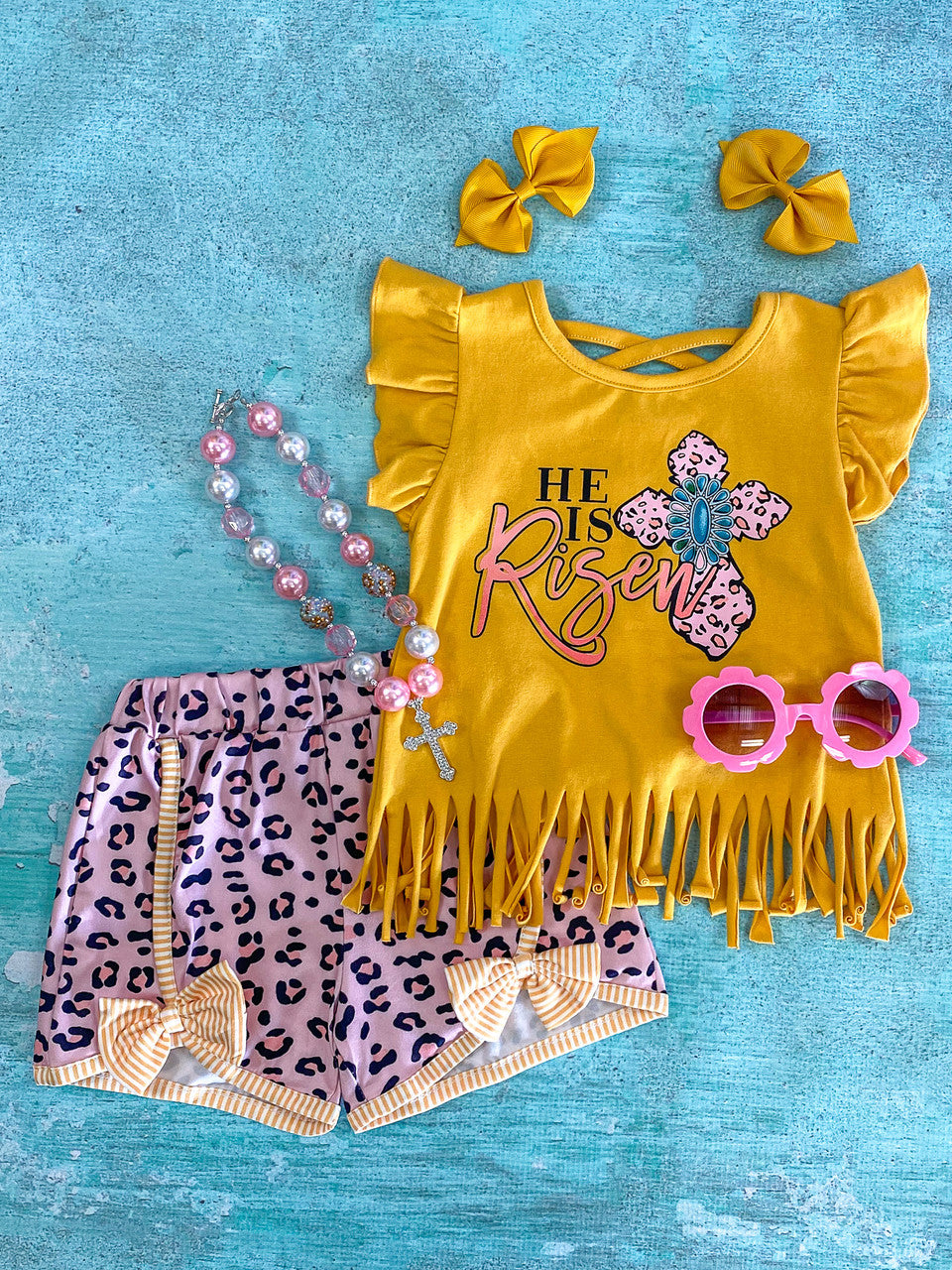 Yellow "He is Risen" Print With Fringe & ruffle flared sleeves, paired with a purple animal print pattern shorts.