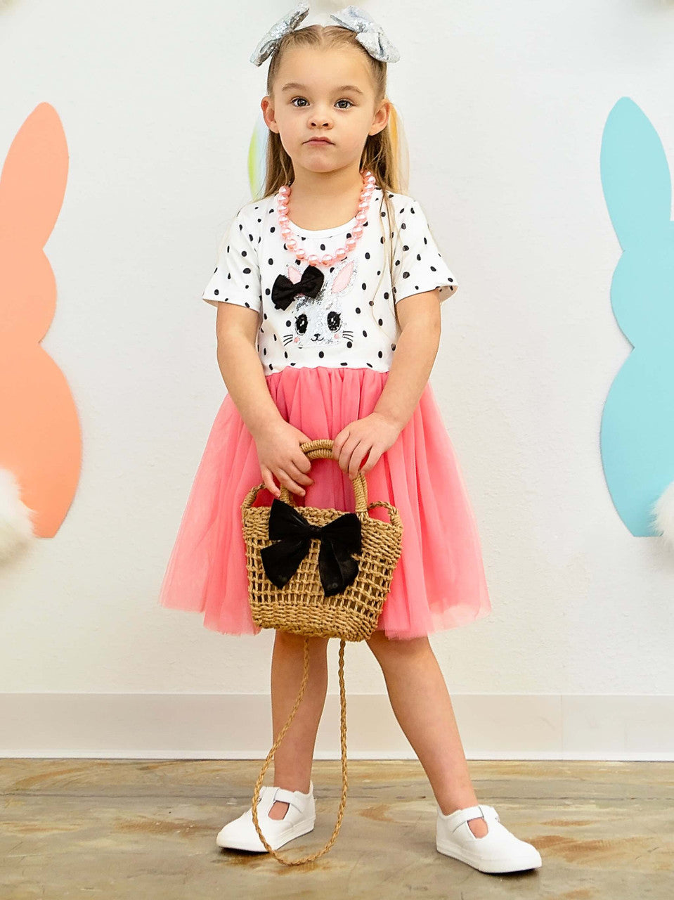 Silver sequin easter bunny with a black bow and black polka dot, short sleeve with hot pink tulle tutu dress on Model.