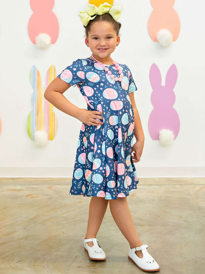 Festive decorative easter egg pattern navy short sleeve twirl dress on model.