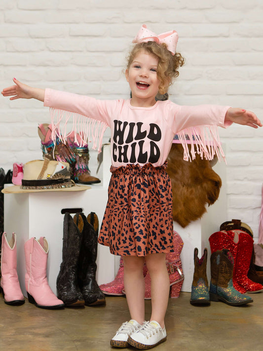 Pink long sleeve fringe top with Wild Child design with animal print skirt on model.