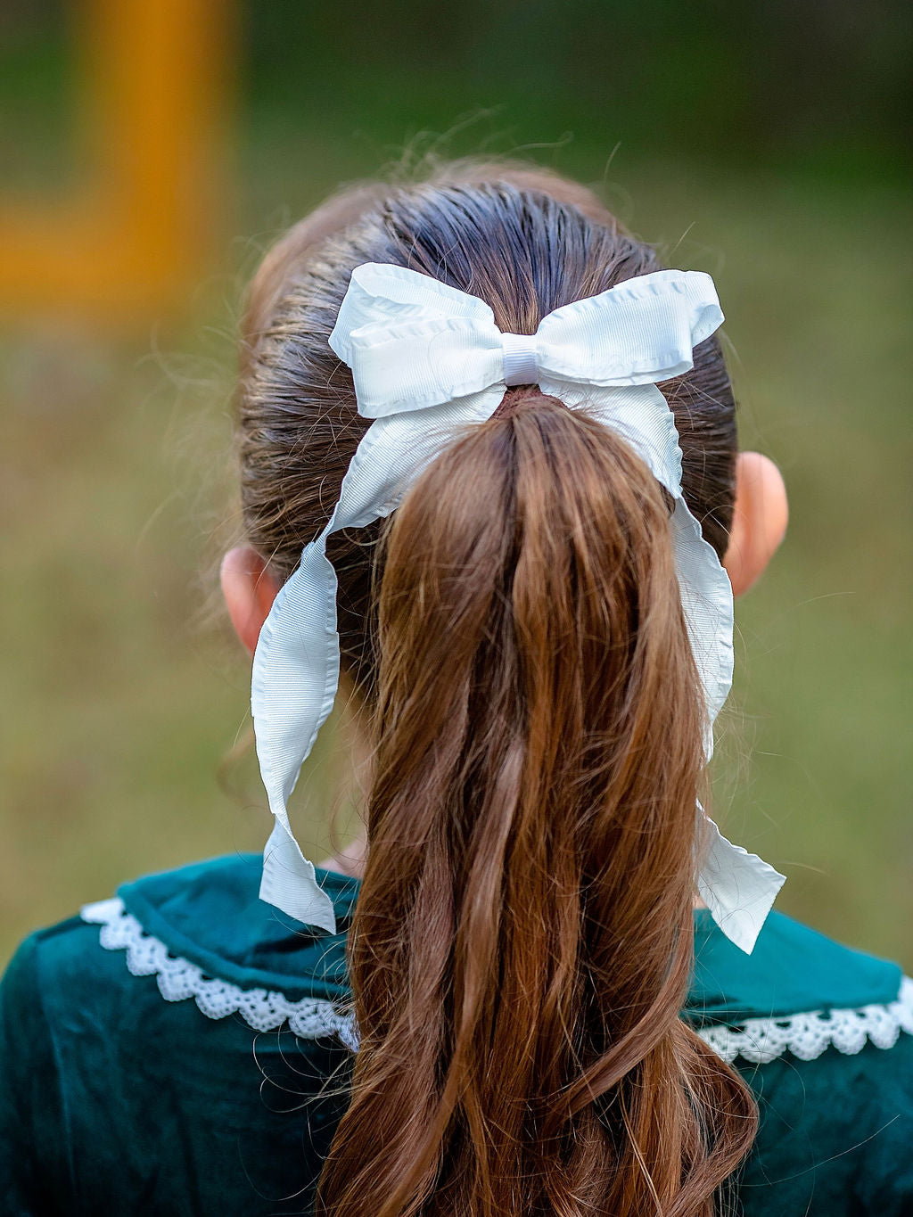 White Ruffle Edge Hair Bow on a model