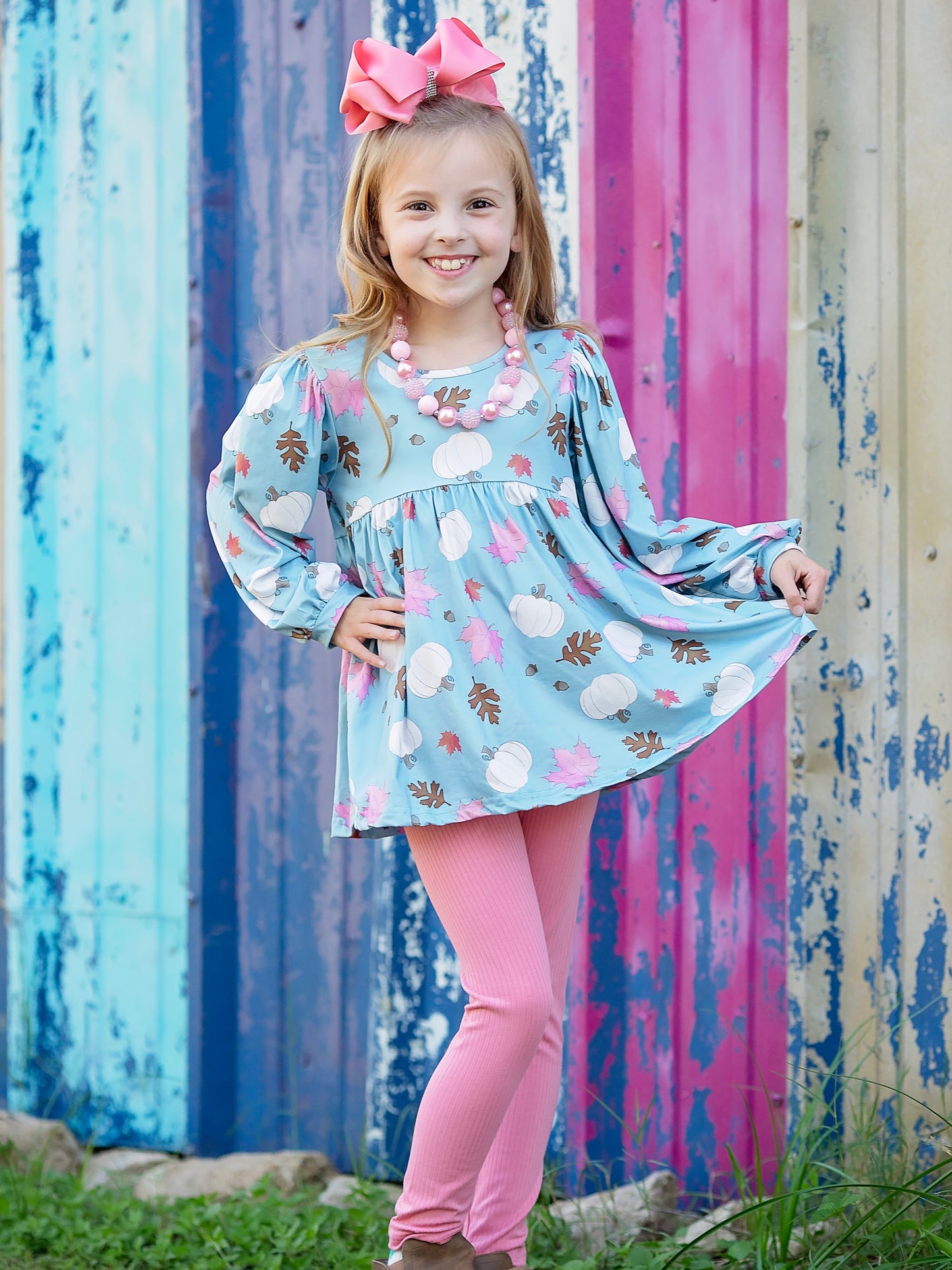 pink and blue fall pumpkin outfit on model