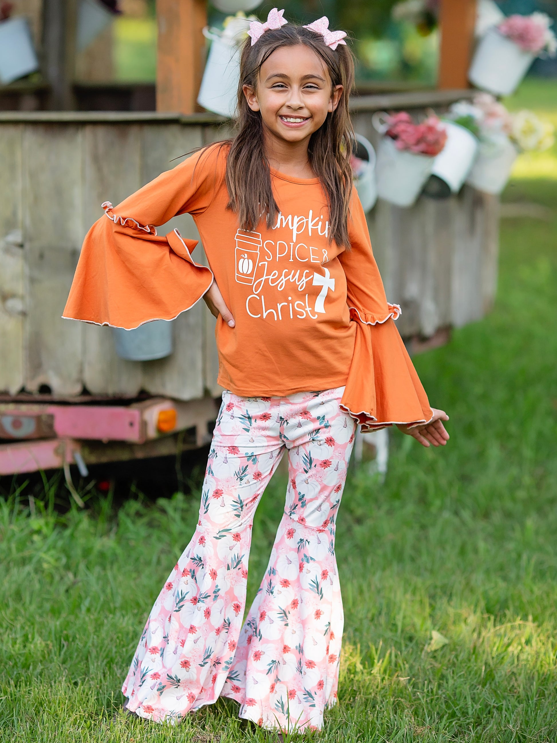 pumpkin spice & jesus christ top and bell bottoms outfit on a model