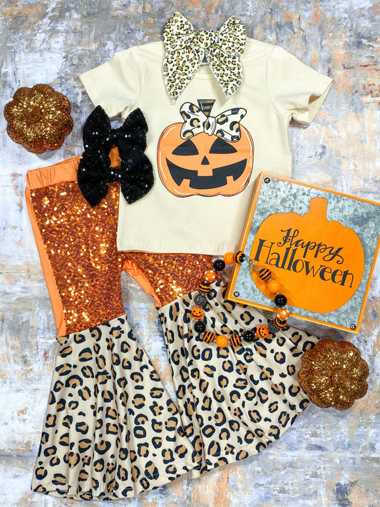 Jack-o-lantern tee in cream with sequins and animal print fabric bell bottoms.