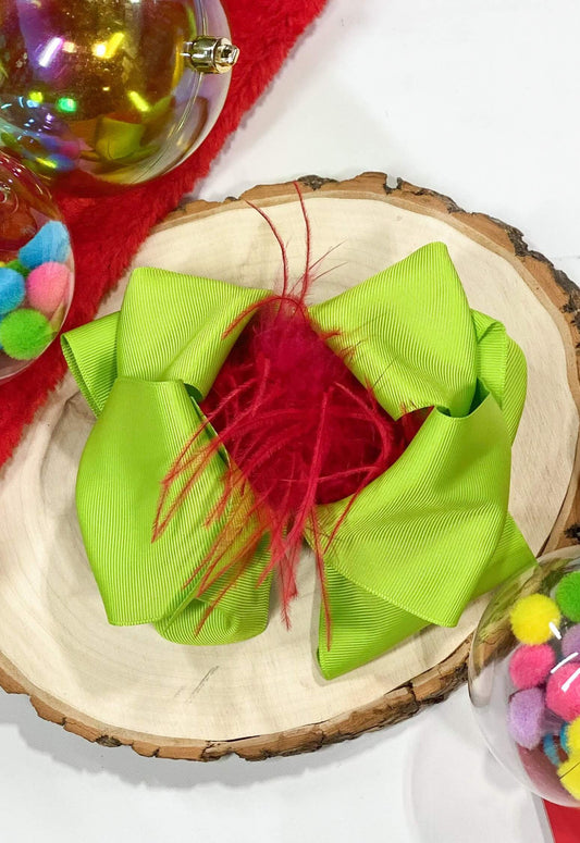 A lime green large double-looped grosgrain ribbon hair bow with a red ostrich feather puff in the center. The perfect Christmas Grinch bow! Attaches with a large 3" alligator clip with "teeth" for a secure hold. The bow measures approximately 6.5" long and 5" wide.