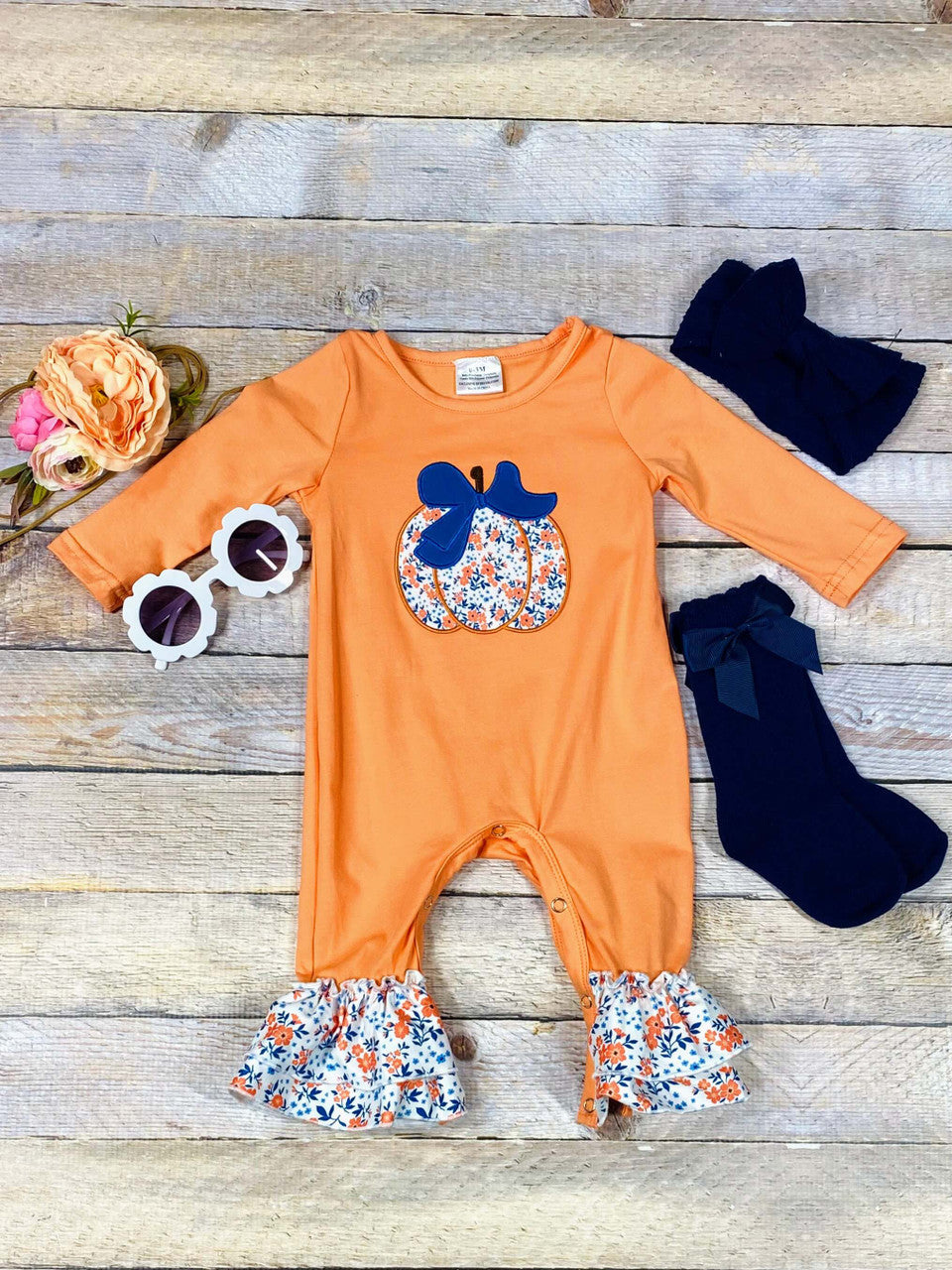 orange onesie with floral ruffles and floral pumpkin 