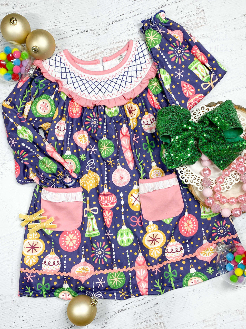 Long sleeve smocked dress in a colorful ornament pattern.