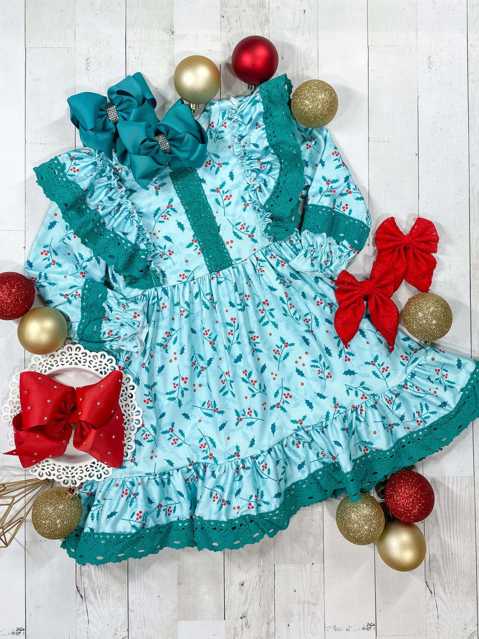 Turquoise long sleeve ruffled dress in a holly print fabric