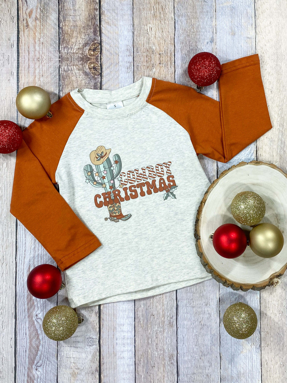 Cactus Christmas design on a heathered grey bodice with rust colored sleeves