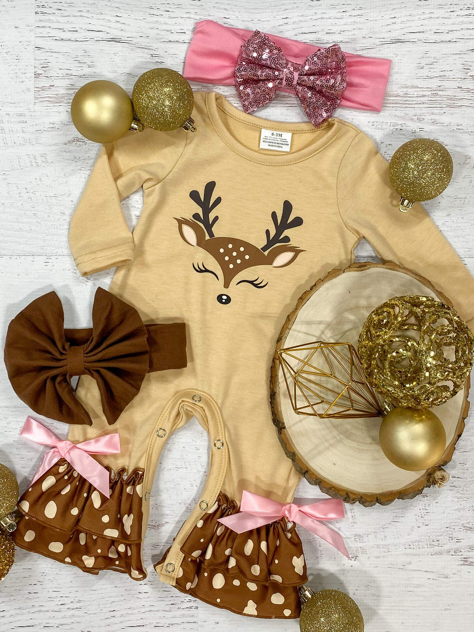 Cream long sleeve ruffled romper with a deer face on the bodice