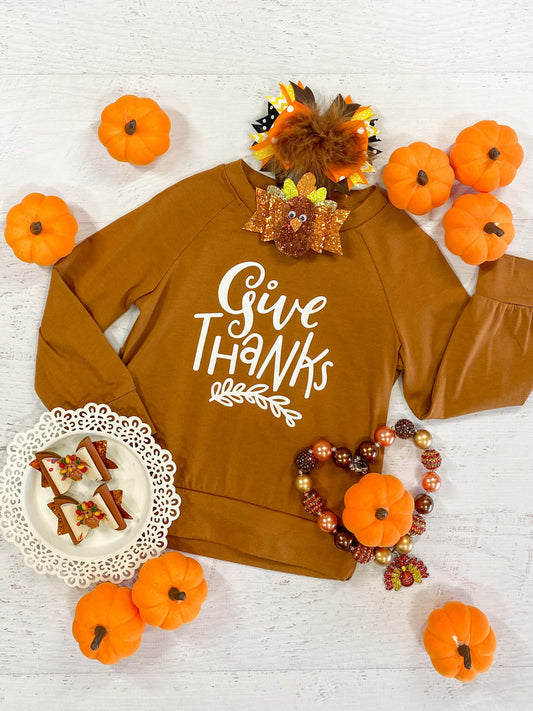 Long sleeve caramel color sweatshirt with a Give Thanks design