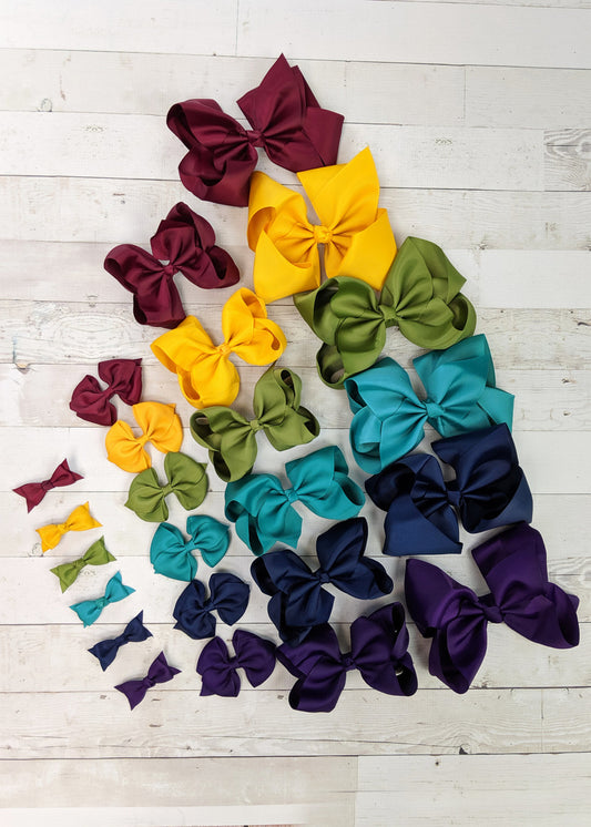 Fall bow sets in your choice of size, each set includes Mustard, Teal, Navy, Olive, Wine, and Eggplant solid color bows in the size of you choice. Each bow has an alligator clip backing.