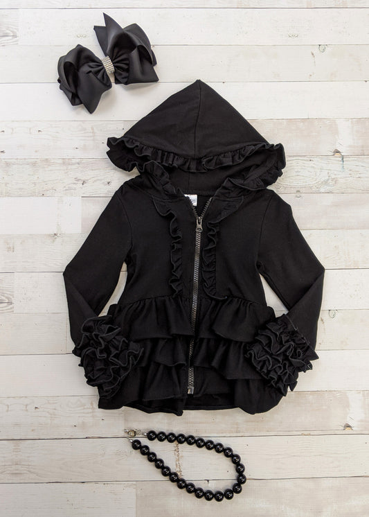 Black zip front hoodie jacket for girls with ruffles on the hood, front, and icing ruffled sleeves. This ruffled hoodie is perfect for layering with our girls outfits and shirts.