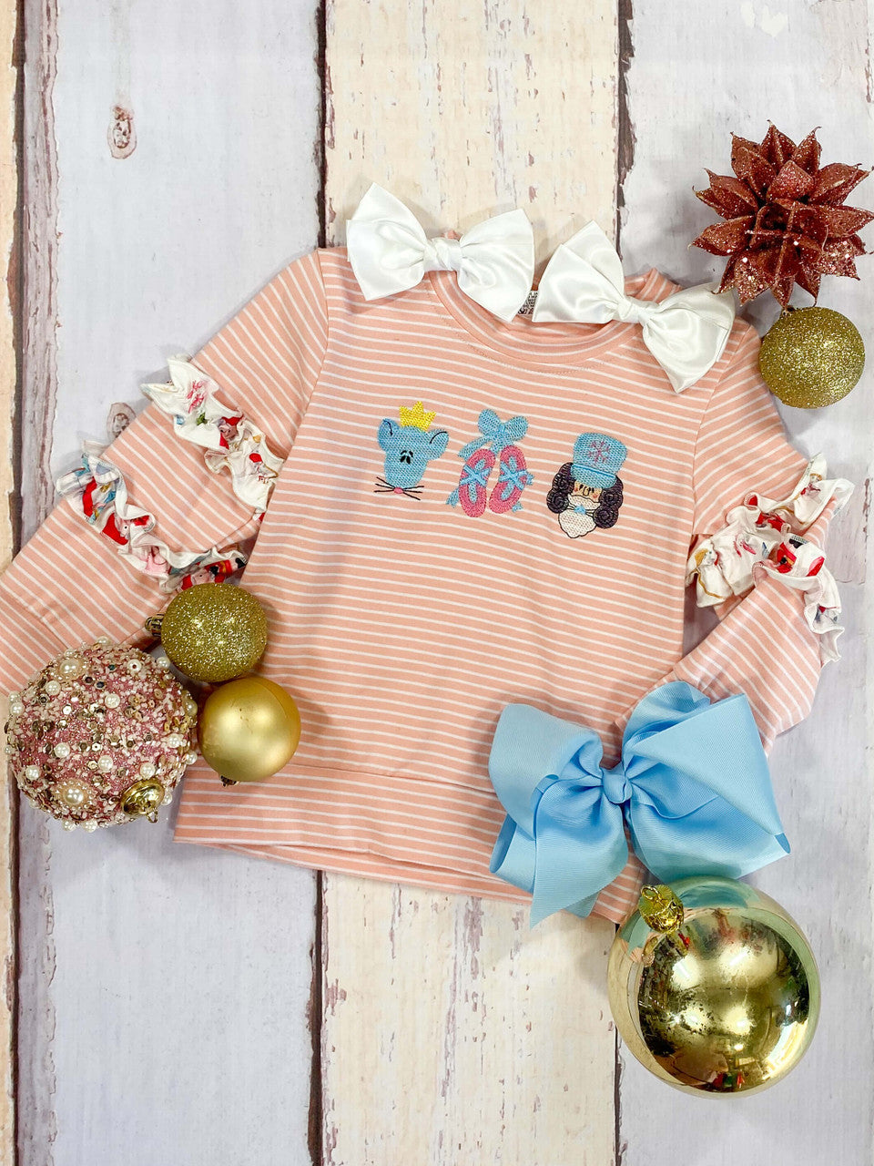 Timeless pink and white striped long sleeve top with a Nutcracker embroidery design and a double ruffle around the sleeves