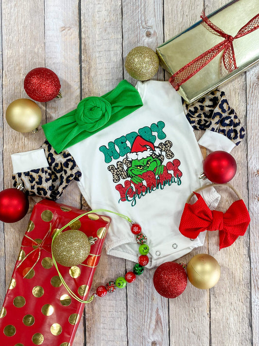 White long sleeve onesie with Grinch design and leopard print sleeves