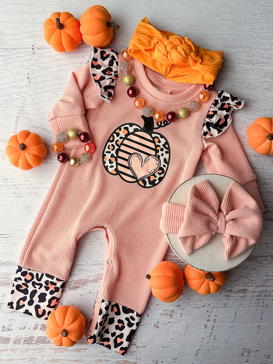 Light pink long sleeve infant romper with pumpkin design, ruffled shoulders and snap closure.