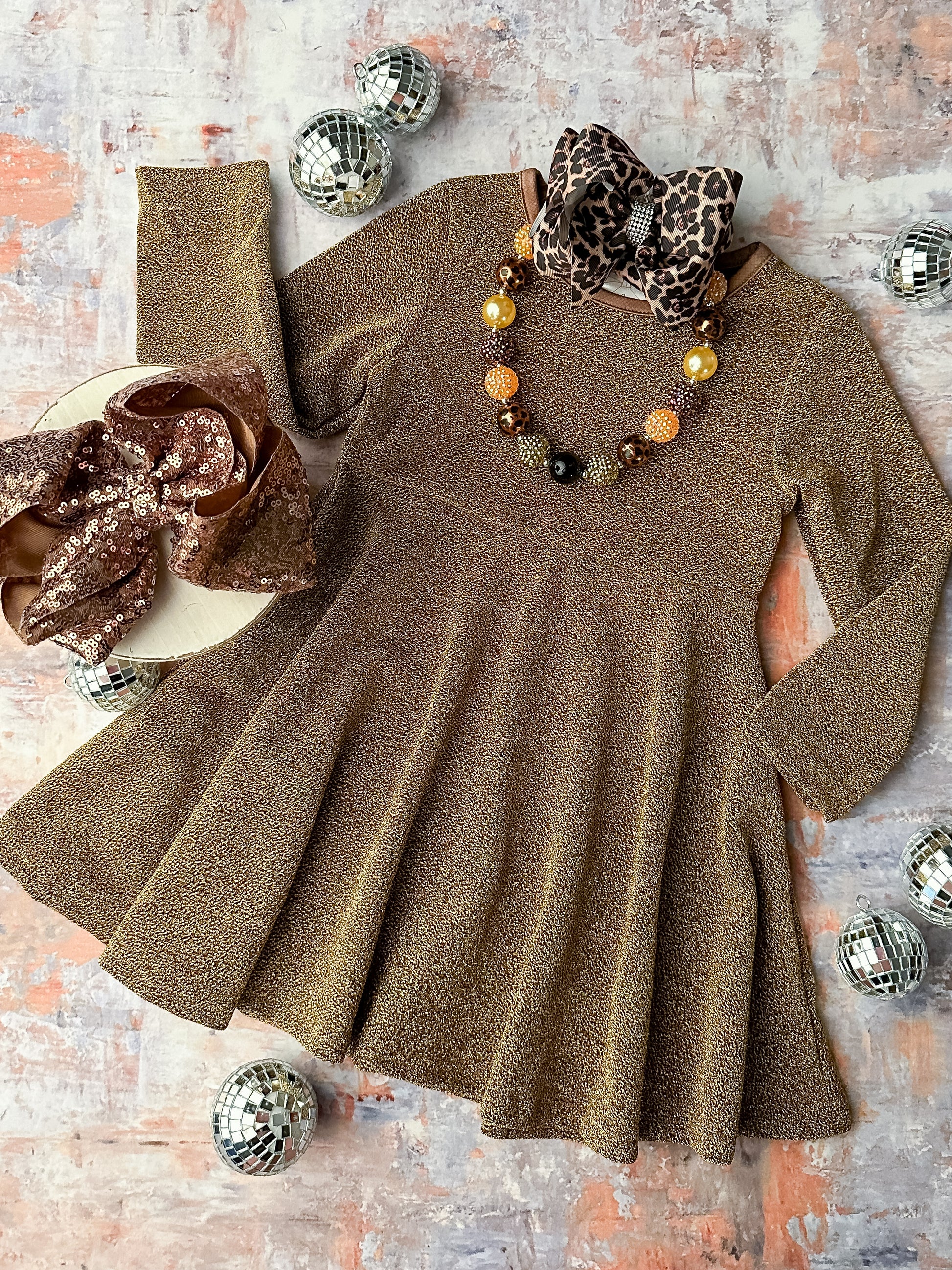 Long sleeve sparkly twirl dress in a golden hue