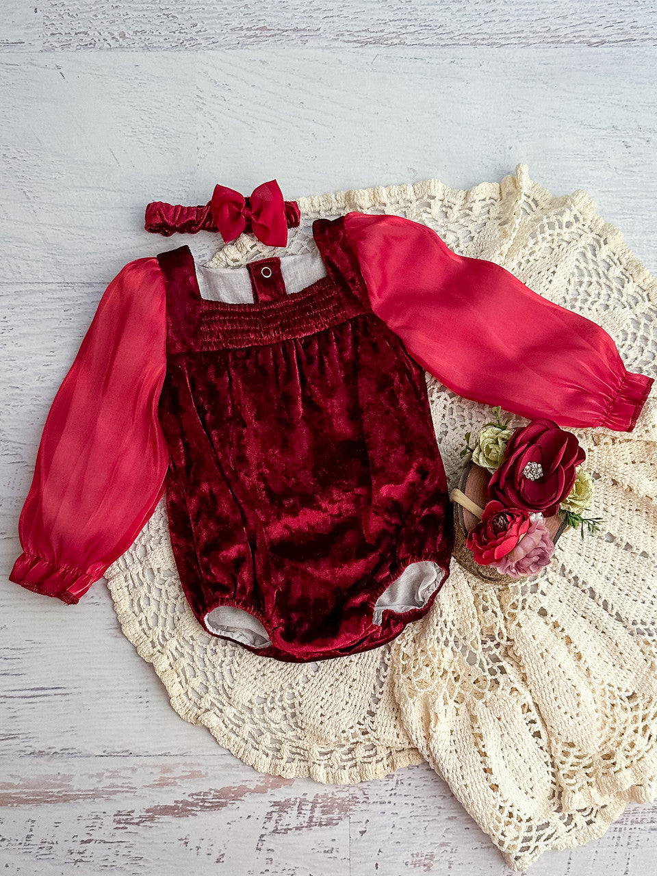 red velvet holiday baby onesie with puff sleeves and bow headband