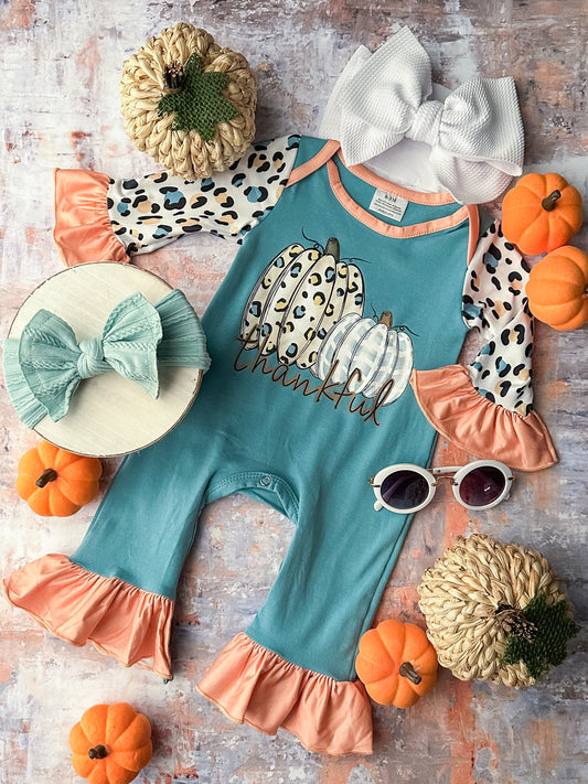 Long sleeve infant romper in slate blue and coral with leopard print detailing, ruffled hems and a pumpkin design.