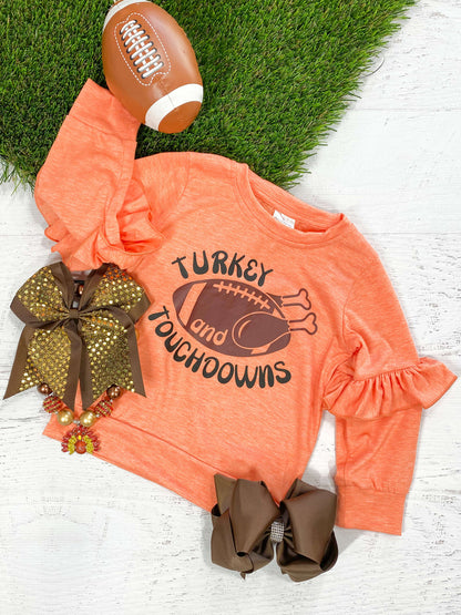 Orange long sleeve ruffle top with a football turkey design