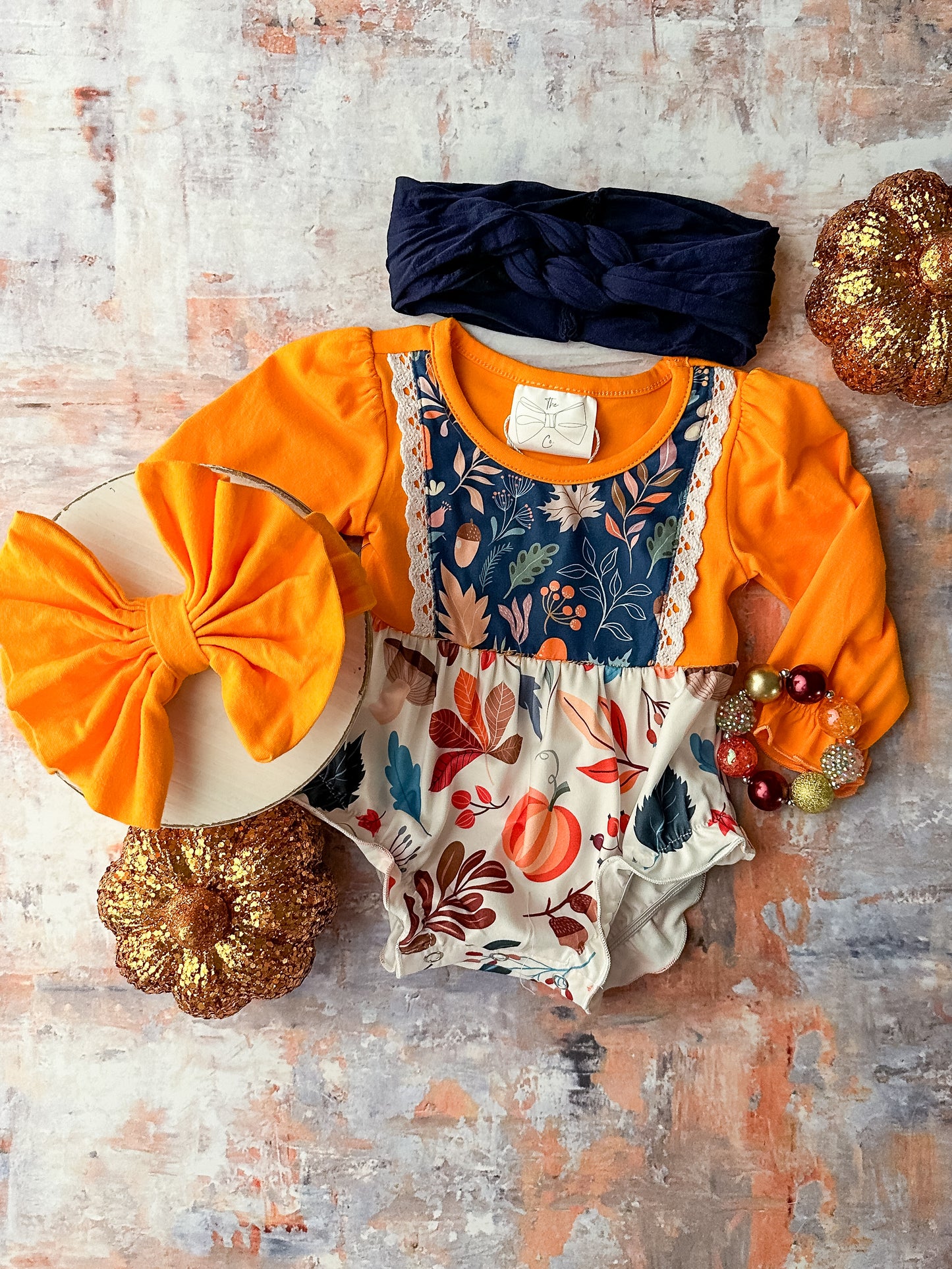 Long sleeve orange infant onesie with autumn fabrics and lace detailing