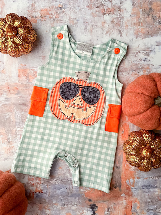 Green gingham sleeveless romper with orange pockets and a pumpkin appliqué.