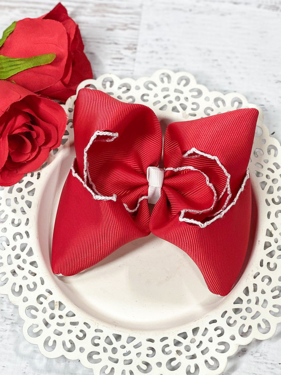 Our moonstitch hair bows are made with 2.25" ribbon and measure approximately 4-5 inches in width with contrast stitch edging.