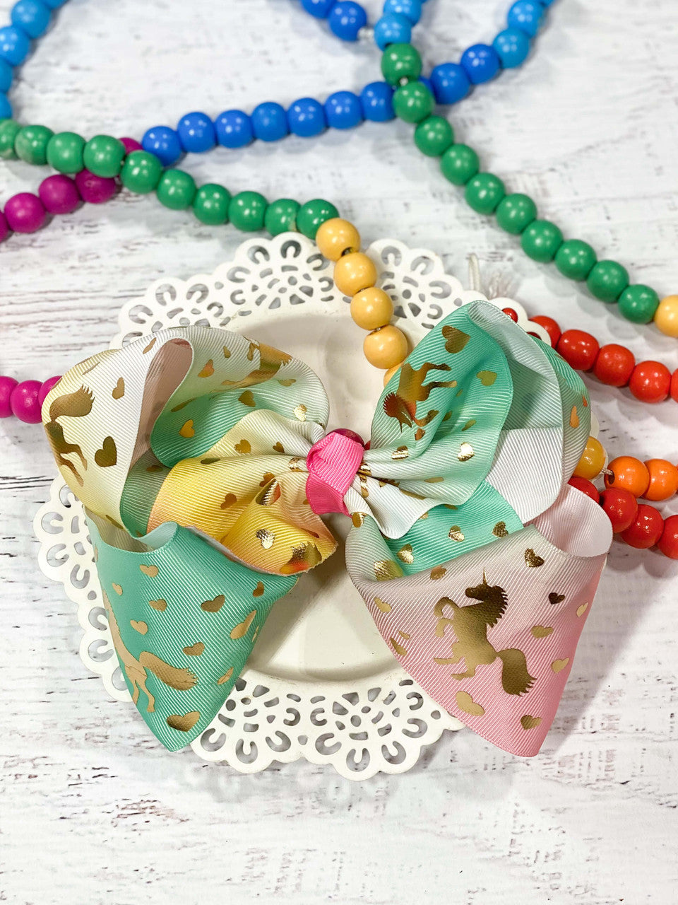 Unicorn hair bow in pastel rainbow and gold foil print. 