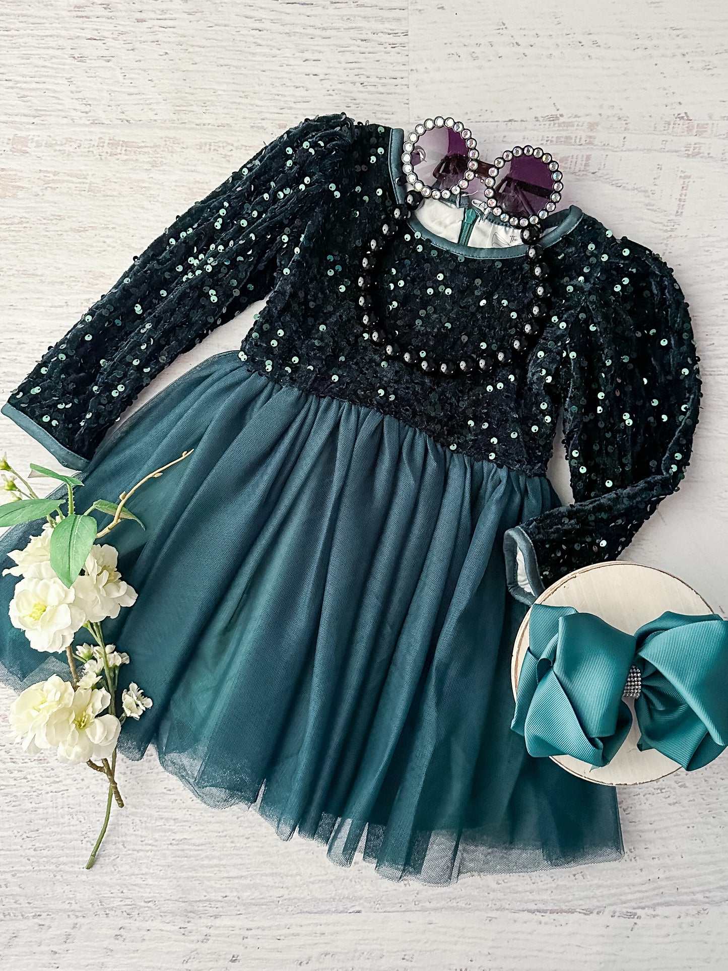 Hunter green long sleeve dress with a sequin top and tulle bottom that zips up the back. 