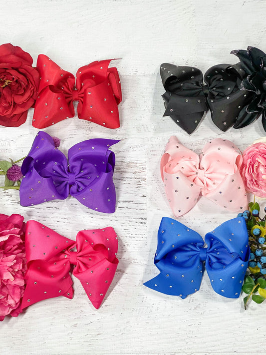 Texas size hair bows sprinkled with rhinestone embellishments! With 3" grosgrain ribbon, each bow measures about 7-8" across. These bows include a toothed style alligator clip to securely attach them.