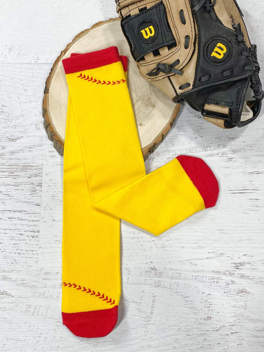 A pair of yellow softball tube socks with red toes and tops, and traditional red softball stitching on a yellow background.