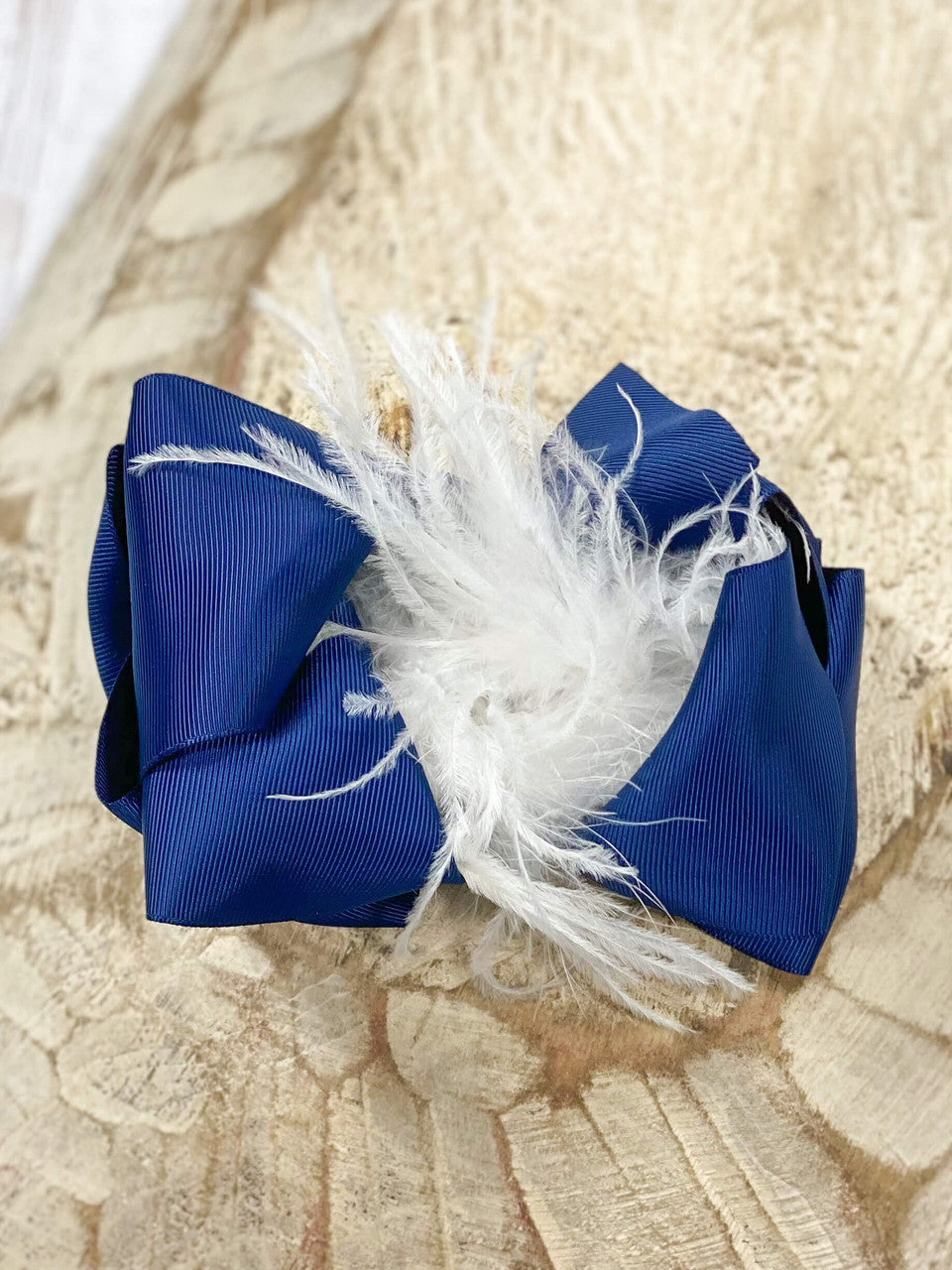These Texas-size navy and white ostrich feather puff hair bows are perfect for your mini all year round. Pair it with any cute outfit for sporting events, family pictures, or holiday events.