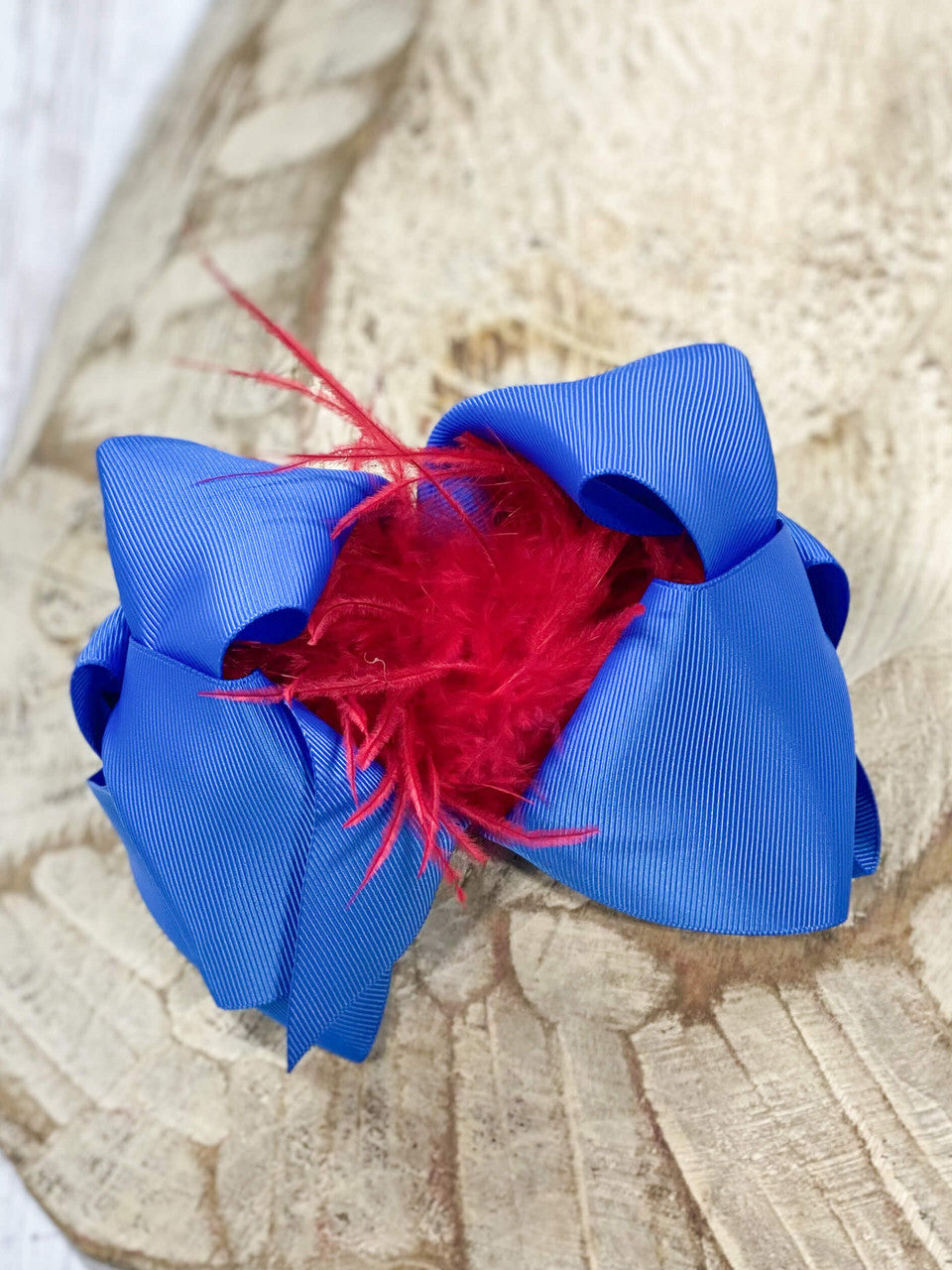 These Texas-size royal blue and red ostrich feather puff hair bows are perfect for your mini all year round. Pair it with any cute outfit for sporting events, family pictures, or holiday events.
