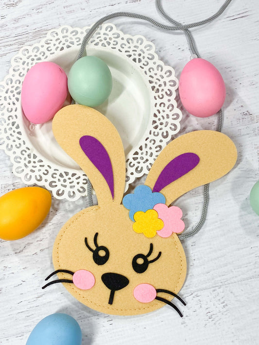 Tan bunny purse with an ear adorned with colorful flowers