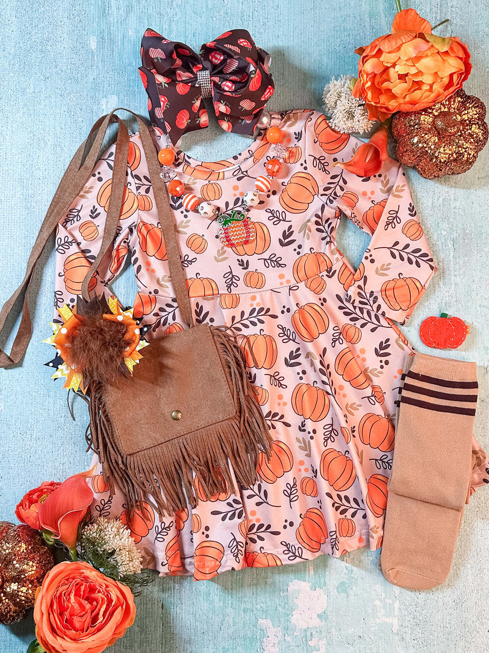 pink long sleeved dress with an abundance of pumpkins