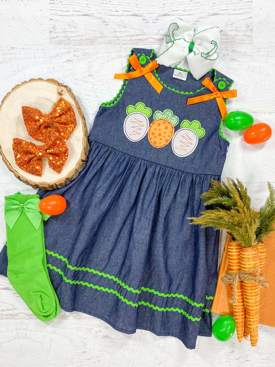 Three carrot patterns, dark denim with green buttons and orange bows, sleeveless dress.