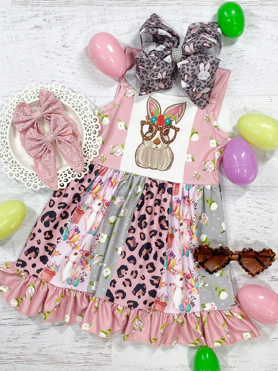 Sweet Easter bunny with a floral crown and animal print glasses. sleeveless dress with animal print, ruffles, and floral patchwork sundress.