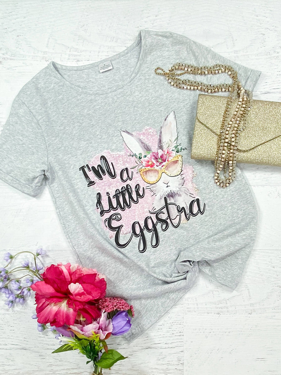 I'm a Little Eggstra Black lettering with an Easter bunny wearing a pink floral crown, crew neck, and grey cuffed shirt - Womens