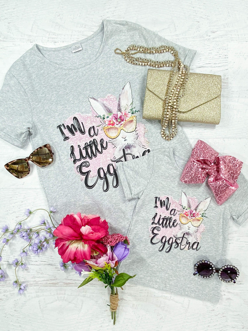 Mommy & Me "I'm a Little Eggstra" Black lettering with an Easter bunny wearing a pink floral crown, crew neck, and grey cuffed shirt