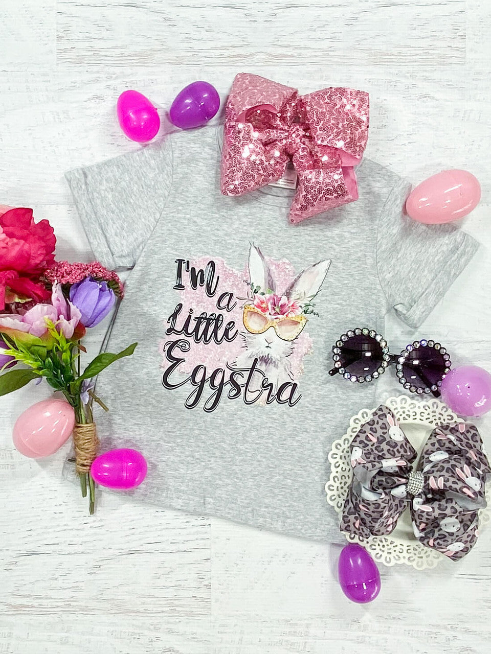 I'm a Little Eggstra Black lettering with an Easter bunny wearing a pink floral crown, crew neck, and grey cuffed shirt - Girls